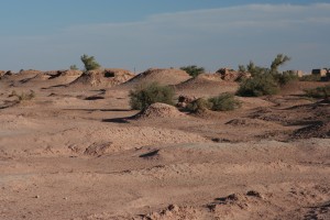 Sahara - The heaps of stone on the surface, resulting from the excavation wastes of the vertical air shaft, show the underground layout of the foggara